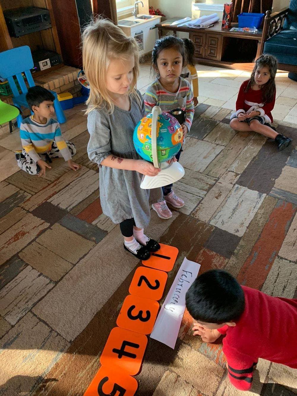 teacher with toddler on lap reading a book